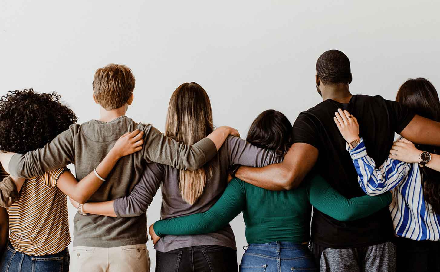 Six people facing way embracing