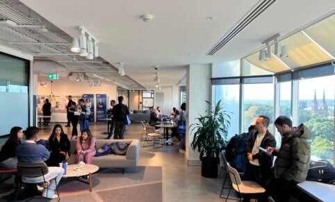 Wide shot of prospective students attending an event on level 12 of the ACAP Sydney campus building