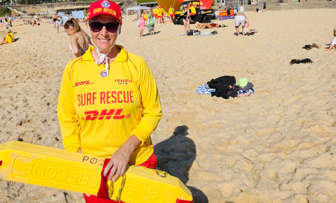 woman in surf life saving outfit on a beach