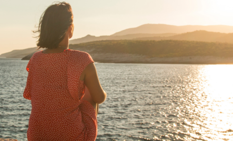 woman staring out over the ocean | [reflective learning]